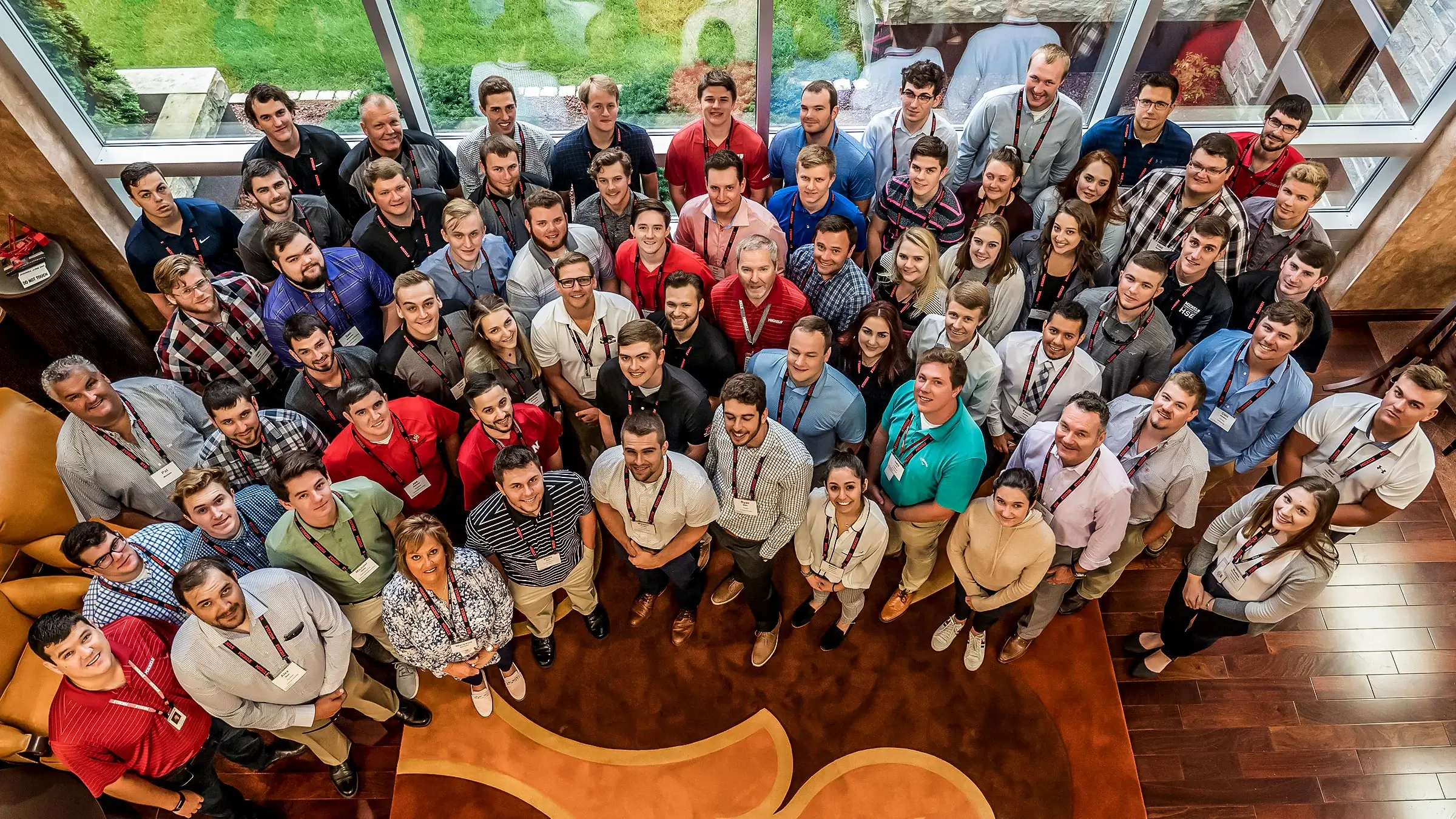 A group of Michels interns in at the Brownsville HQ stand alongside senior leadership.