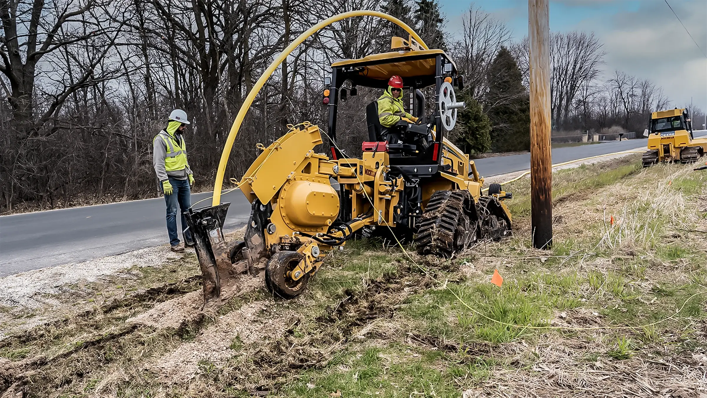 Michels uses a plow rig to bury plastic gas distribution pipe along a roadway