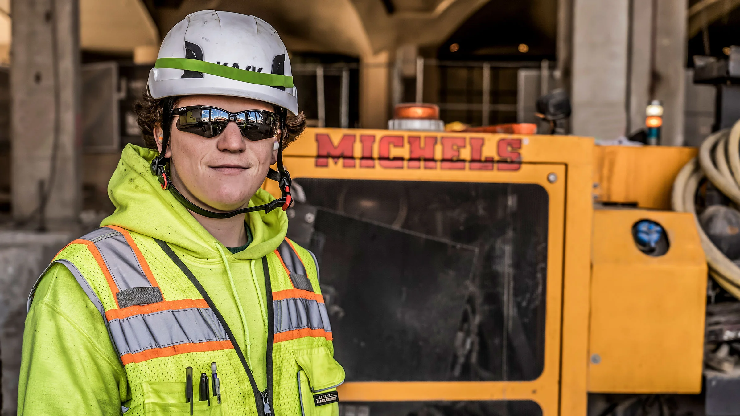 A man smiles for the camera while on a jobsite.