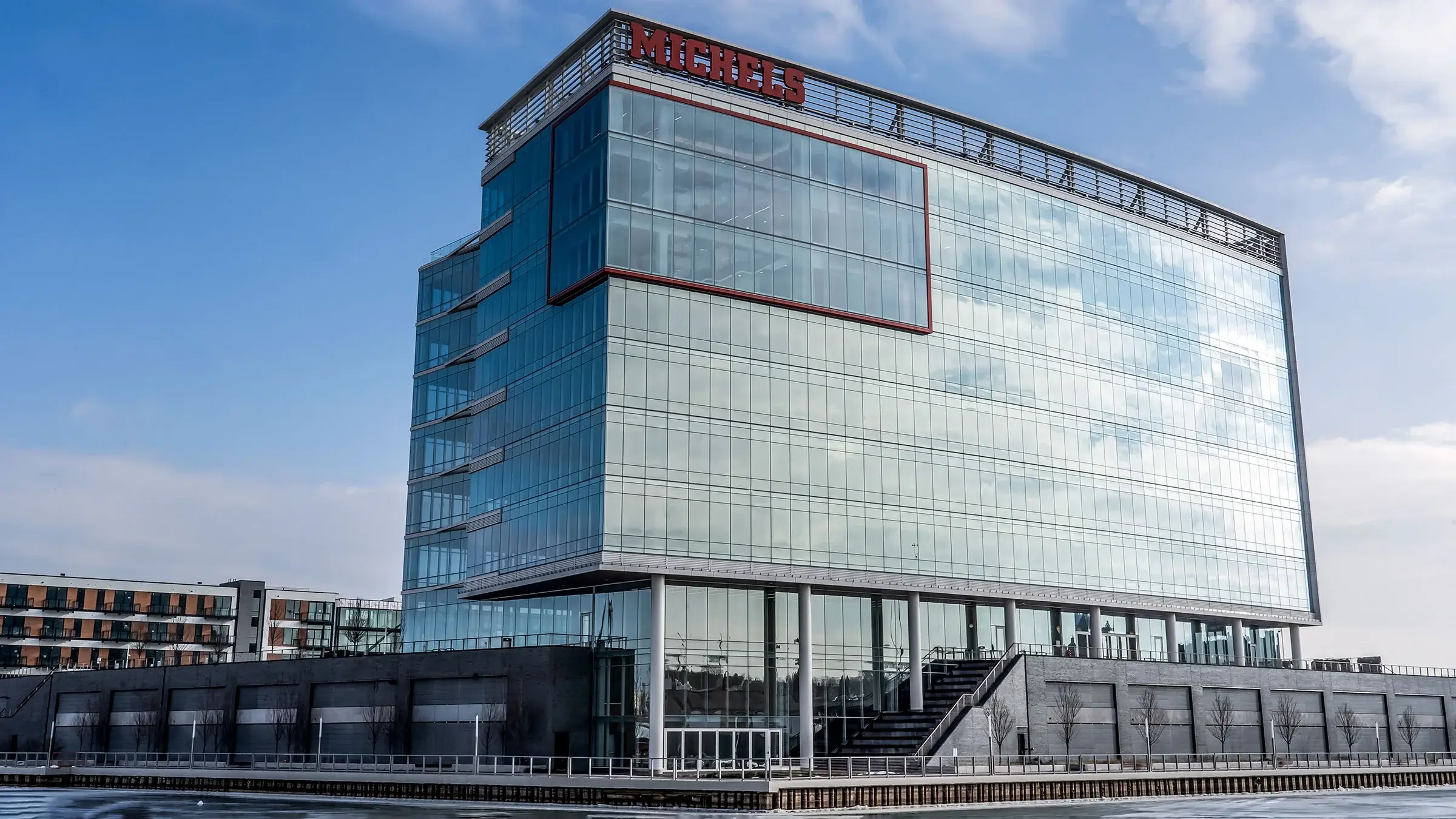 R1VER building on a partly cloudy winter day.