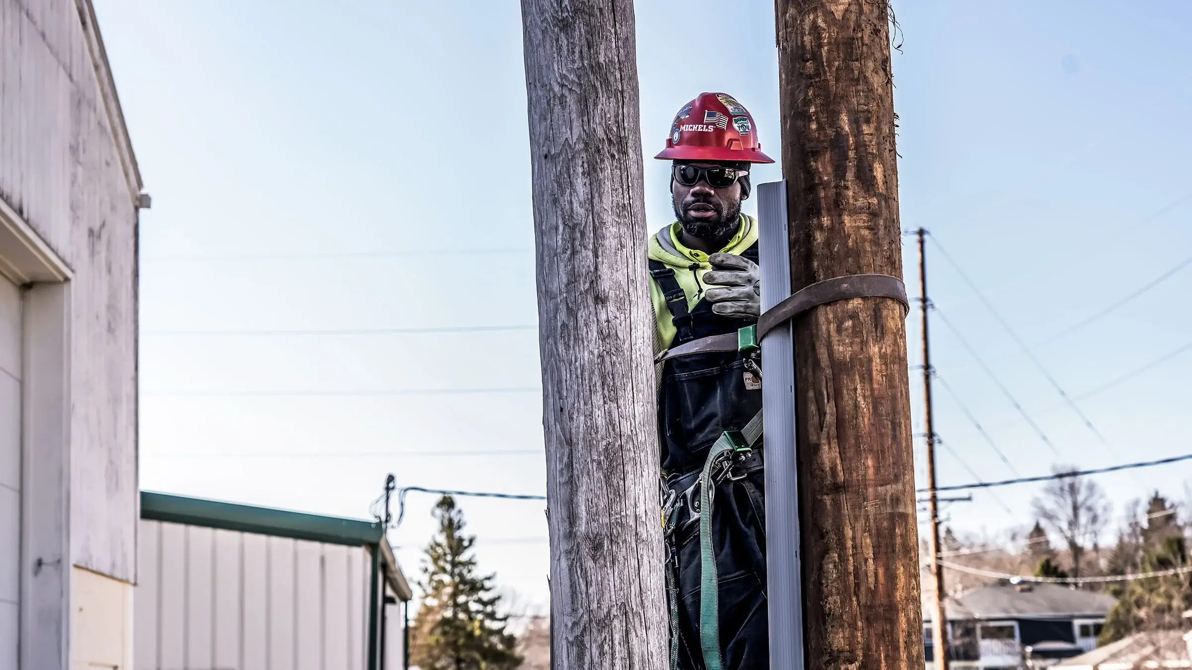 Lineworker replacing old power pole with new.