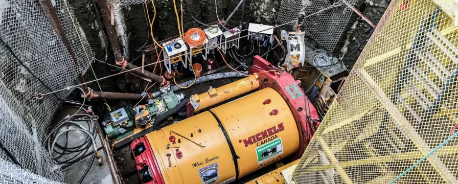 A tunneling drill at the bottum of a deep shaft.