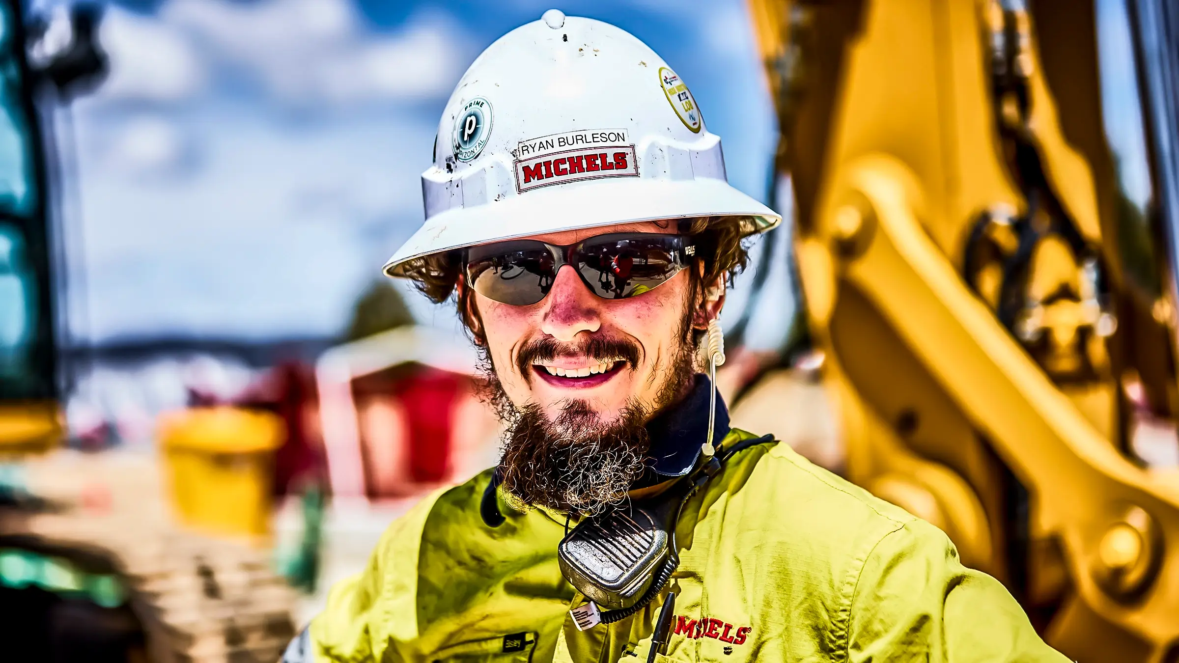 Man in hard hat smiles for camera.