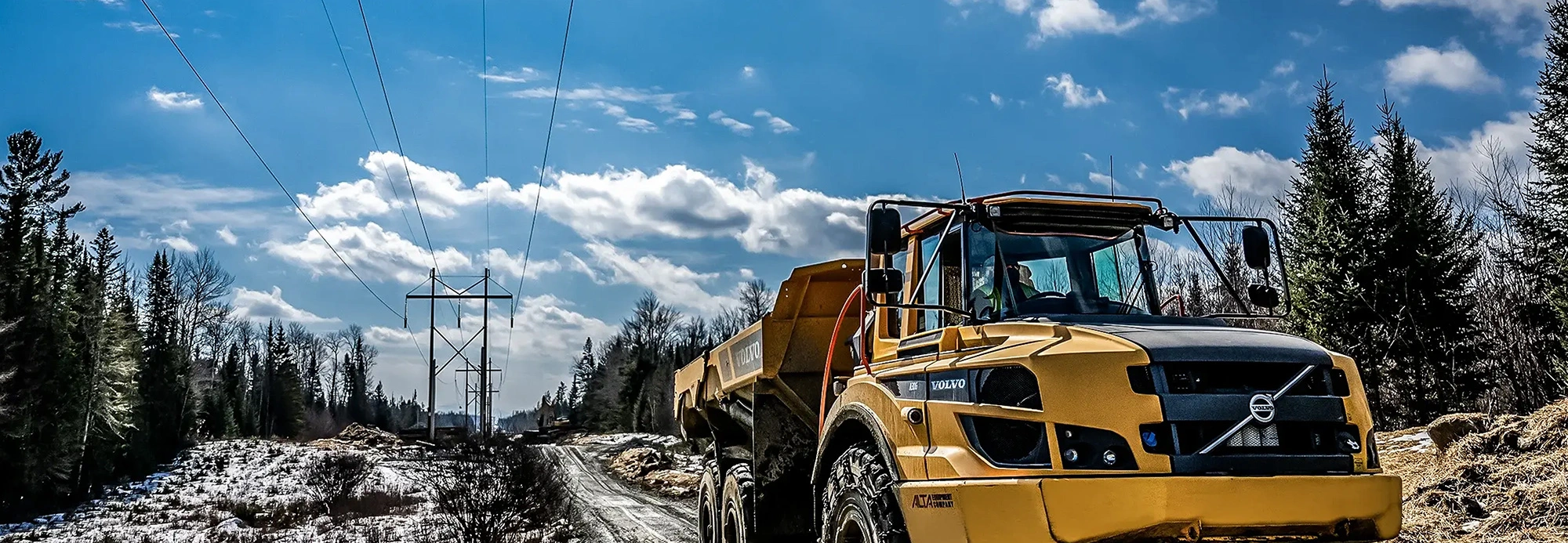 Large yellow truck on a dirt road