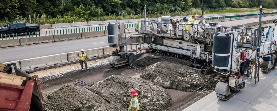A paving machine paves a major interstate.