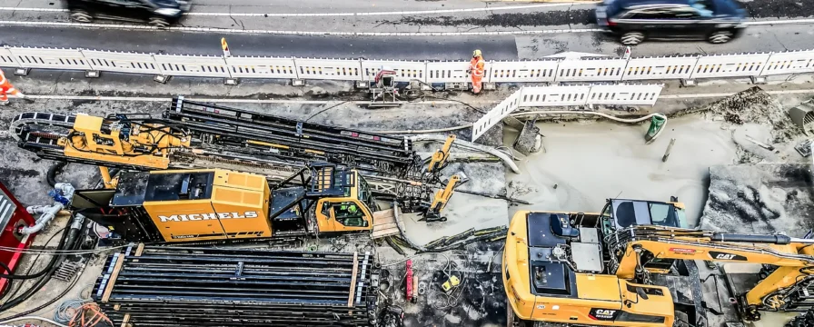Horizontal directional drill rig operates near a busy German roadside.