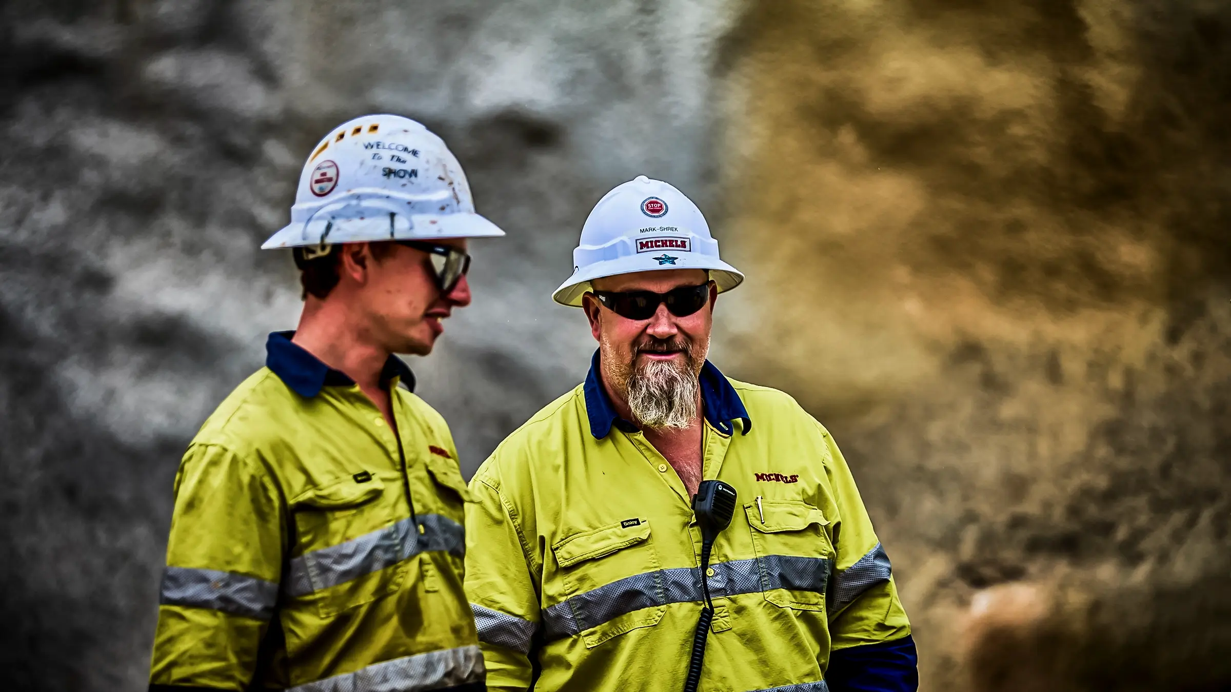 Two crew members standing together with PPE on.