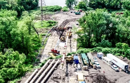 A large scale pipeline project near a riverside.