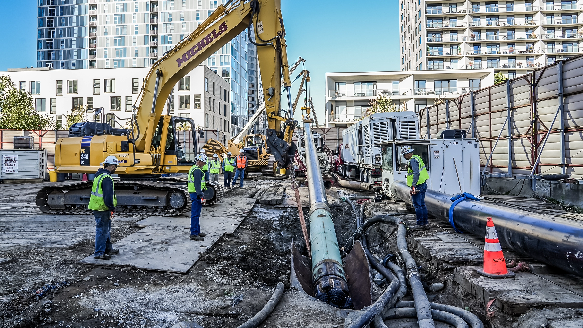 A large diameter HDD pipeline being strung into the ground in a city enviornment.